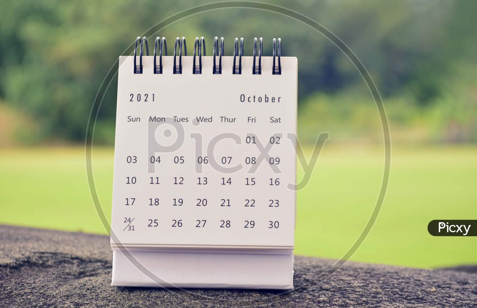 October 2021 White Calendar With Green Blurred Background