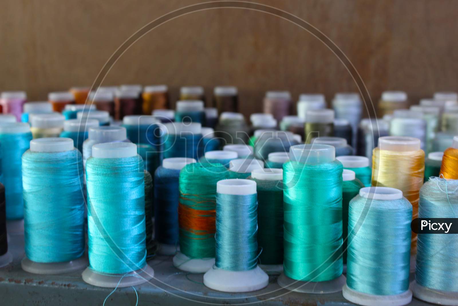 Different Color Spools Of Thread For The Textile Industry. Background