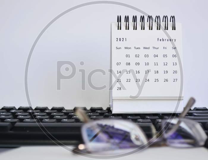 White February 2021 Calendar On A Blurred Keyboard With White Background