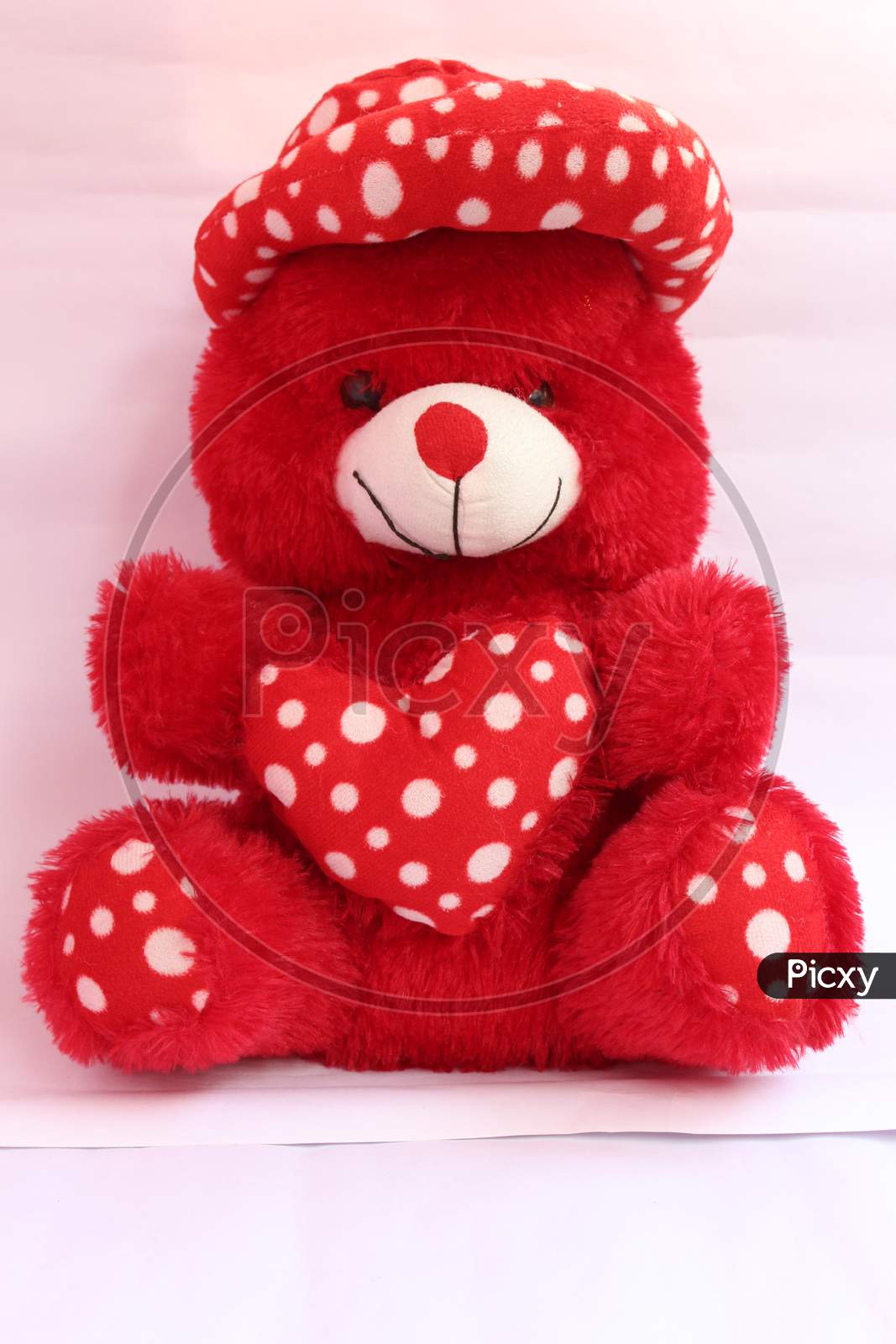 Lovely Red Teddy Bear With Red Heart On White Background