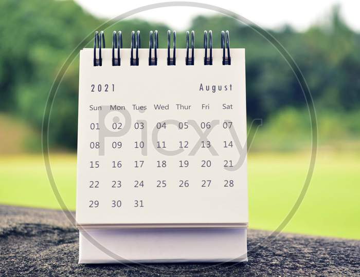 August 2021 White Calendar With Green Blurred Background