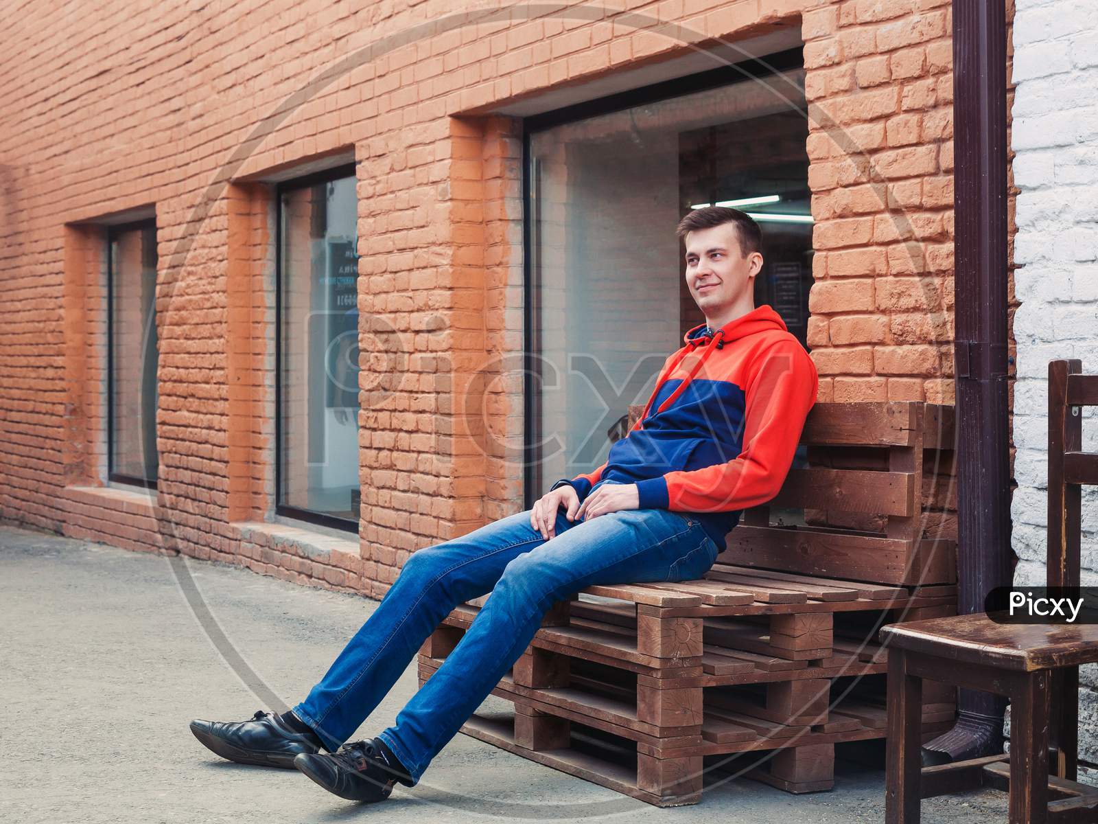 Man Sitting On A Fashionable Bench