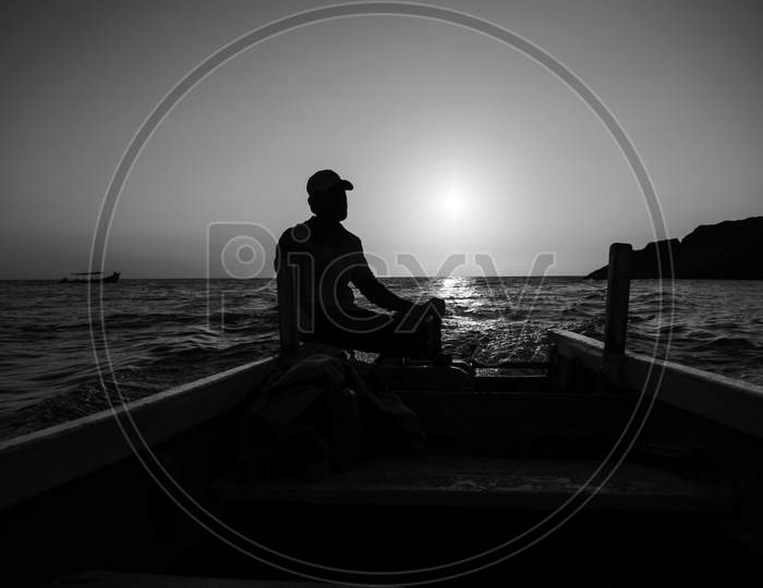 A Boat Man Near The Shore Of Om Beach