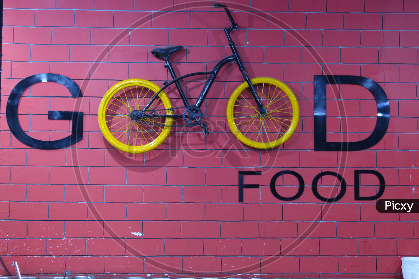 Inscription Good Written With Letters And A Bicycle On The Background Of A Brick Wall. Eco-Friendly Transport Concept