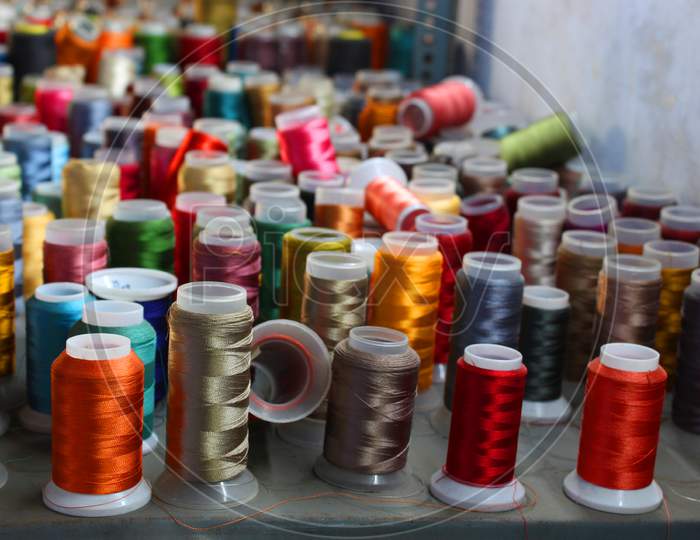 Different Color Spools Of Thread For The Textile Industry. Background