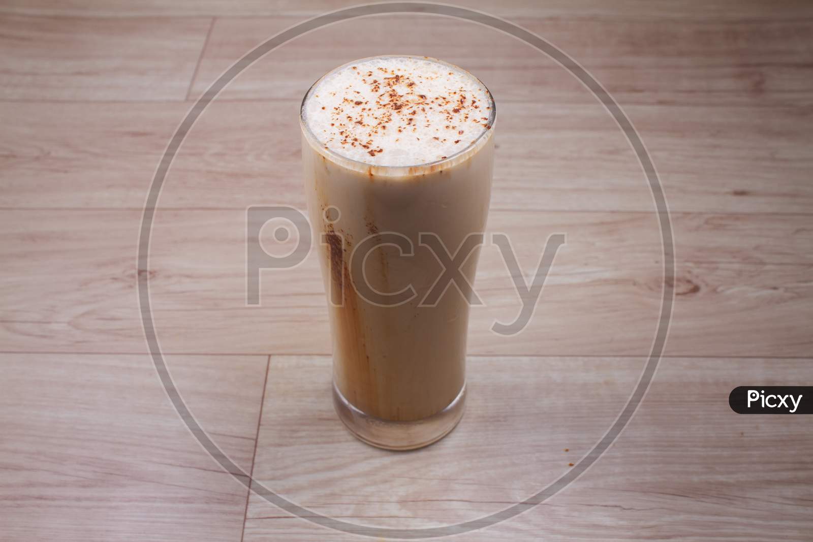 Cold Coffee Milkshake Smoothie Drink In A Glass With Coffee Beans On A Rustic Wooden Table With Copy Space.