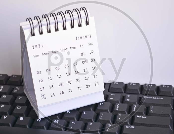 White January 2021 Calendar On A Blurred Keyboard With White Backgrounds. New Year Concept