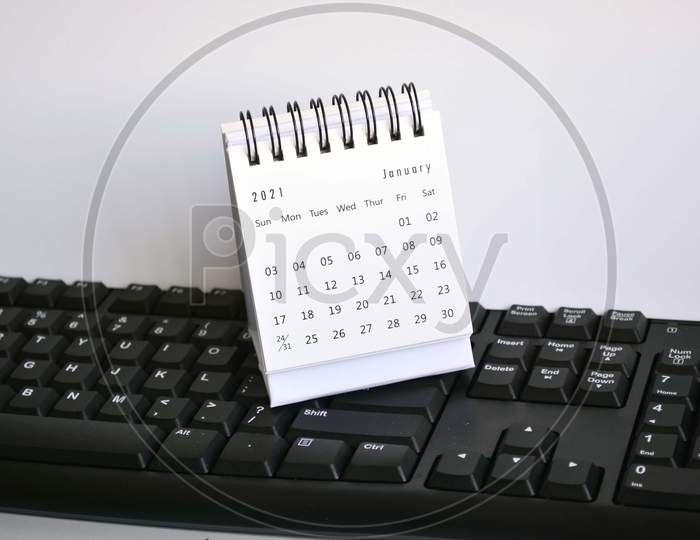 White January 2021 Calendar On A Blurred Keyboard With White Backgrounds. New Year Concept