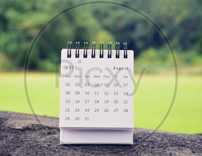 August 2021 White Calendar With Green Blurred Background