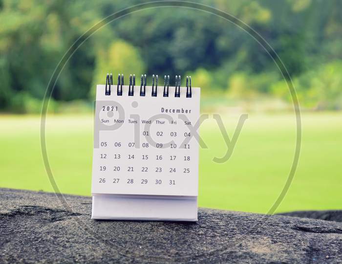 December 2021 White Calendar With Green Blurred Background