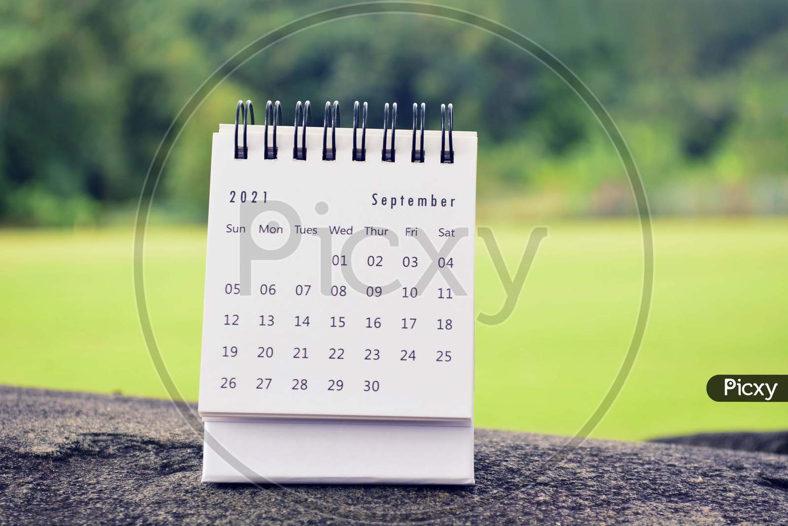 September 2021 White Calendar With Green Blurred Background