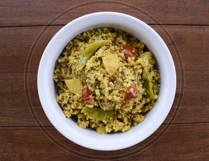Traditional Indian Fasting Food Recipe Dish Called Bhagar Homemade Of Barnyad Millet Rice Grains. Also Known As Samo Or Sama Pulao Rice Khichdi. Indian Fasting Food Dish On Wooden Background
