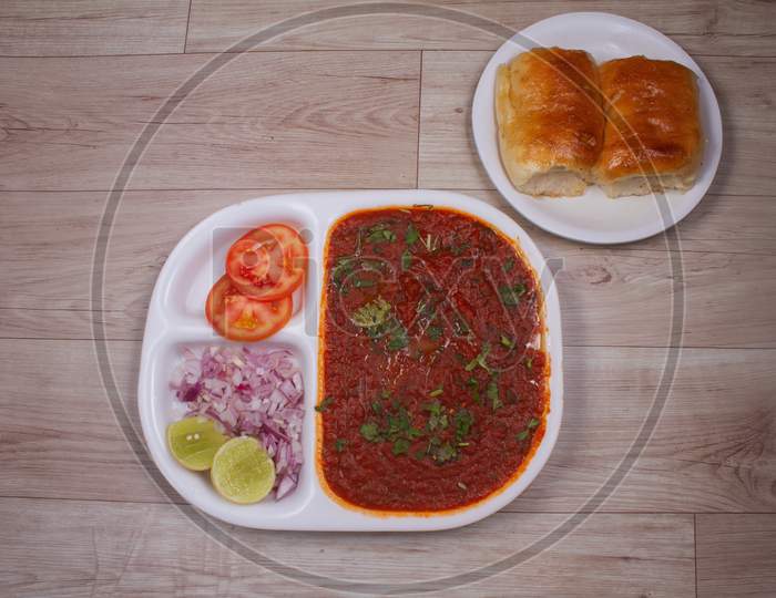 Indian Mumbai Food Pav Bhaji From Vegetables With Bread Close-Up In A Bowl On The Table. Horizontal Top View From Above
