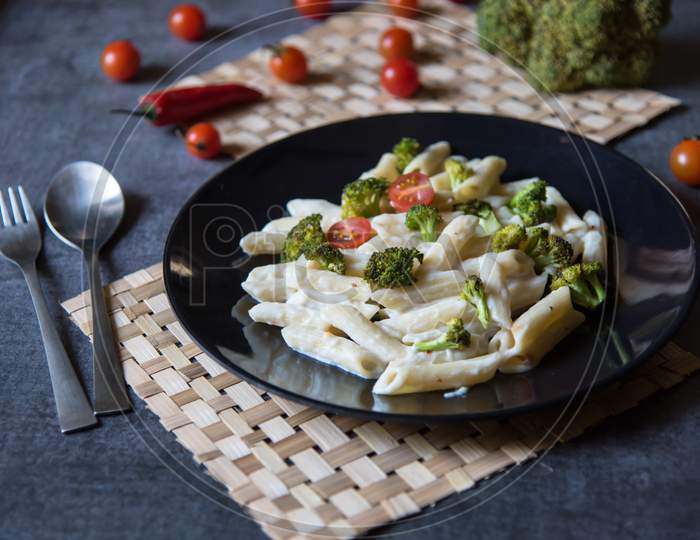 Italian food pasta with spinach, cherry tomatoes and broccoli