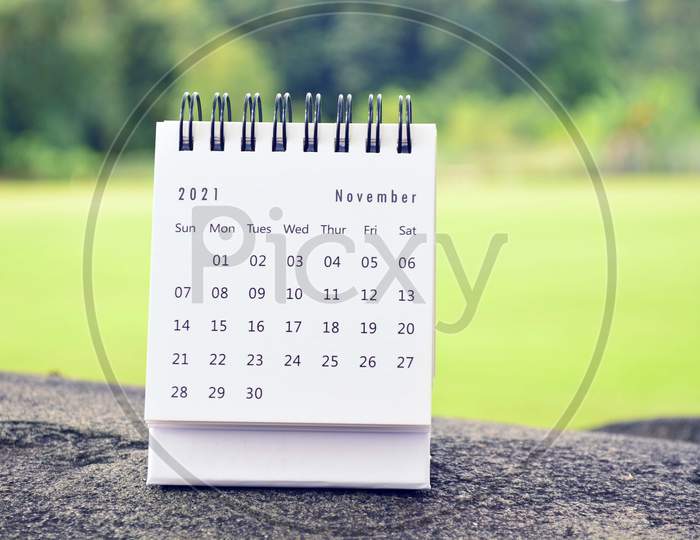 November 2021 White Calendar With Green Blurred Background