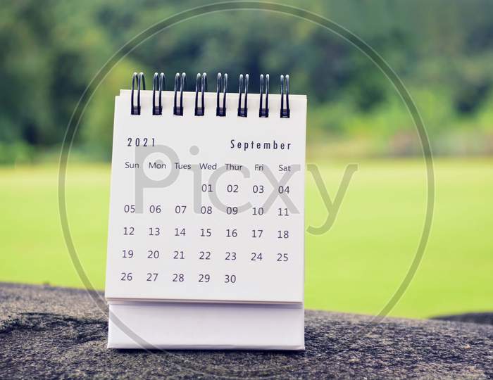 September 2021 White Calendar With Green Blurred Background