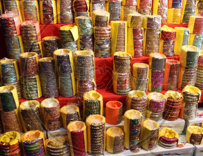 Background Of Colorful Bangles Stacked In A Shop In India With Glitter And Plain Colored Bangles. The Bangles Are Made Of Glass, Metal Or Lac And Worn Regularly Or On Special Occasions By Indian Women