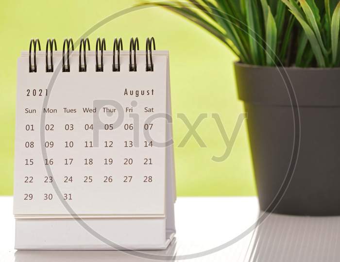 White August 2021 Calendar With Green Backgrounds And Potted Plant. 2021 New Year Concept