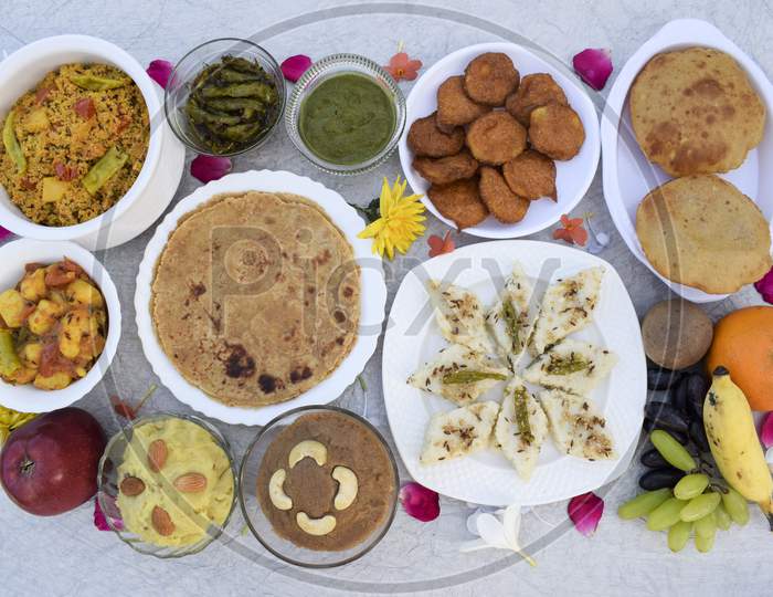 Farali Vrat Thaali Homemade Items Rajgira Sheera, Paratha, Puri Bhajiya Or Pakoda. Sabudanaflour White Dhokla, Sweetpotato Dessert Halwa, Falahar Mix Fruits, Mint Chutney, Chilly Peanut Pickle, Bhagar