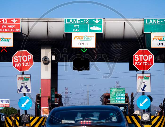 Wide Angle Shot Of Toll Booth In India With The Fast Tag Fastag Signs On All Lanes Showing The Mandatory New Rfid Based Cashless Payment System From The National Highway Authority Of India