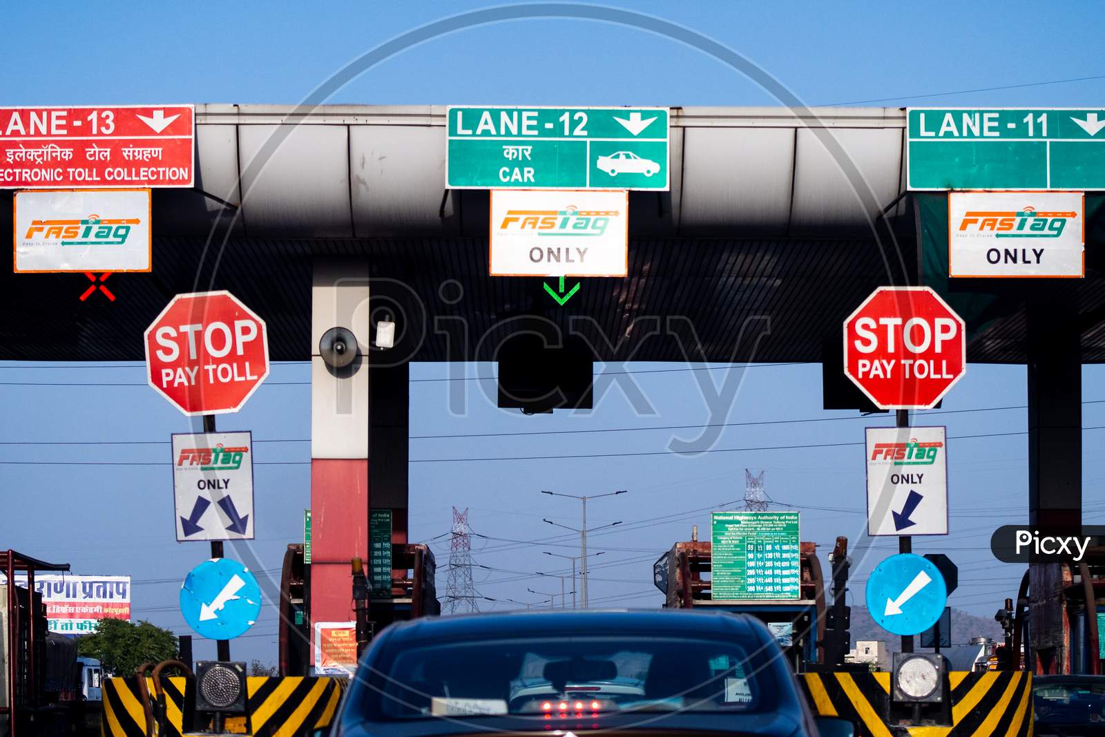 Wide Angle Shot Of Toll Booth In India With The Fast Tag Fastag Signs On All Lanes Showing The Mandatory New Rfid Based Cashless Payment System From The National Highway Authority Of India