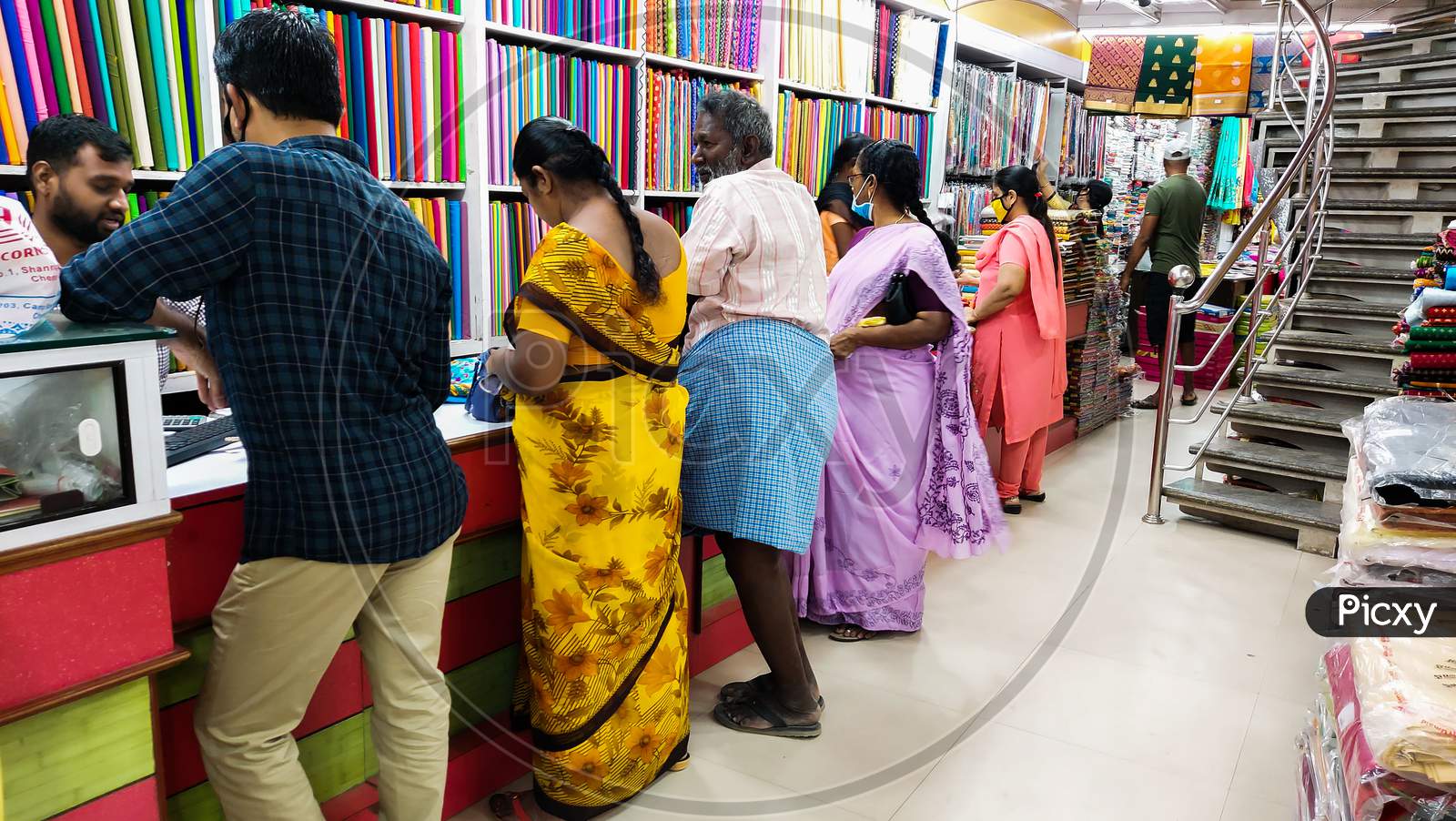 People standing in cloth shop to buy clothes