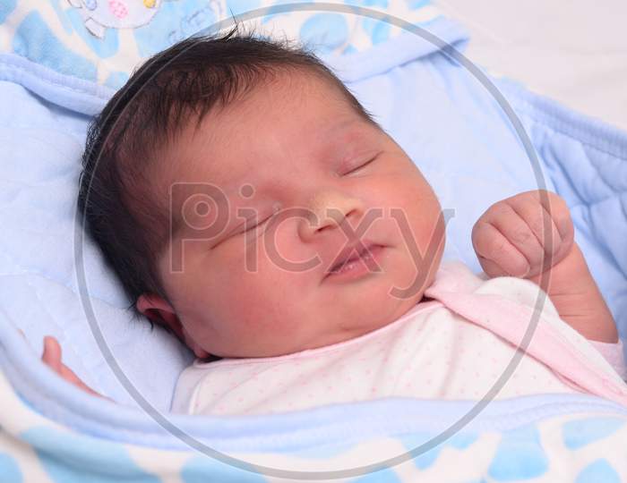 New Born Infant Asleep In The Bed