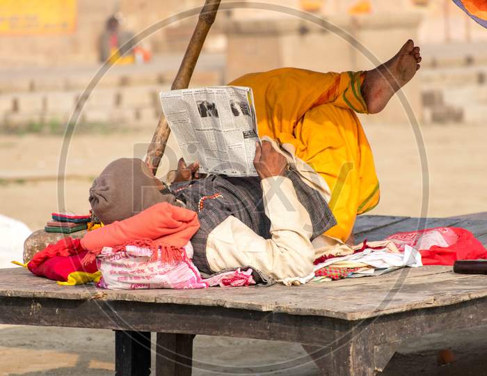 Sadhu reading news paper.