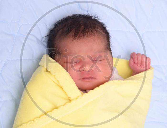 The Sleeping Newborn Girl Or Boy Lies On The Bad