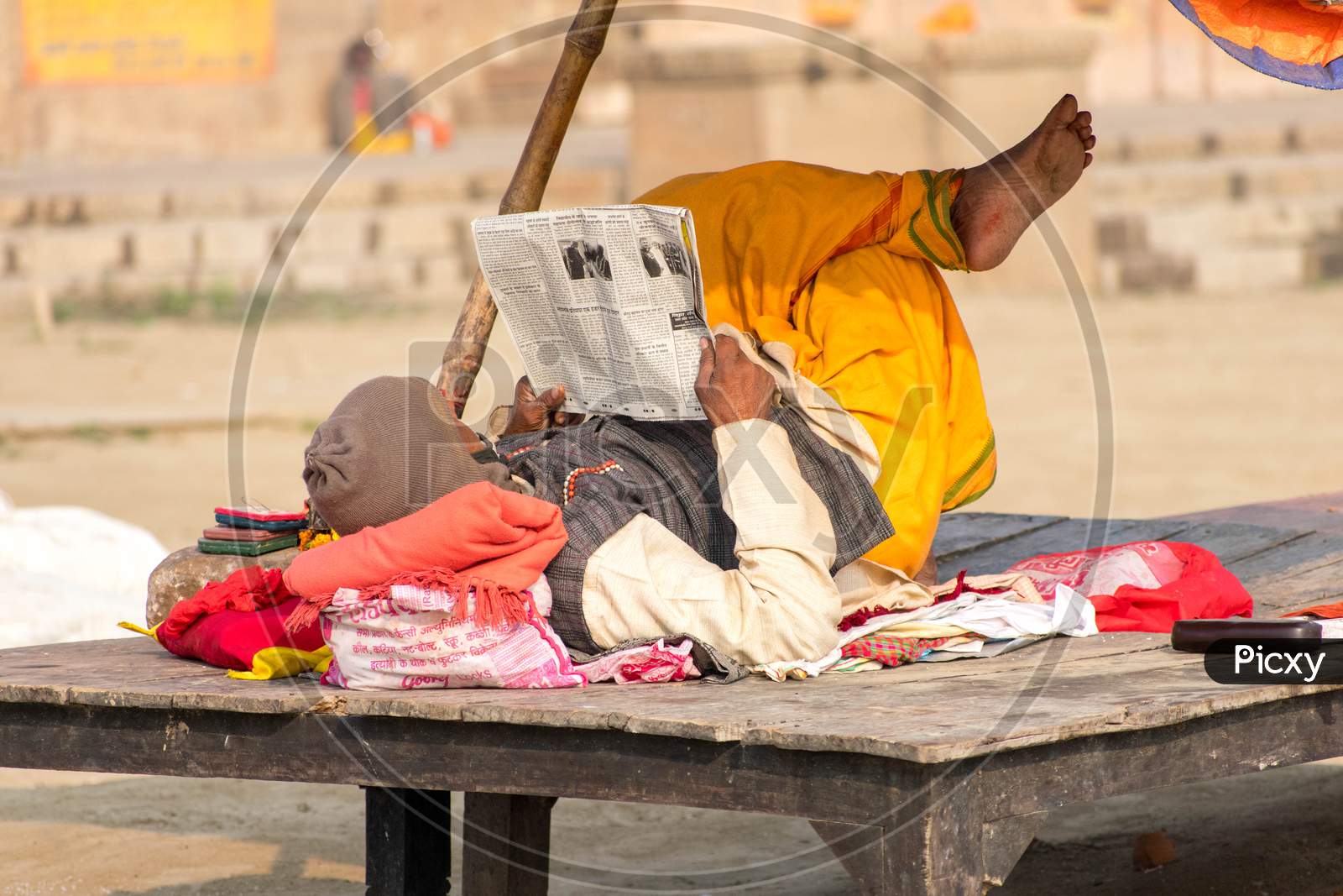 Sadhu reading news paper.