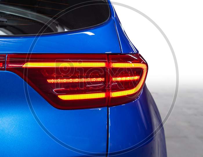 The Back Of A Blue Expensive Crossover Car:  Bumper, Trunk Lid, Taillight On The Back White Background. Mock Up For The Advertising Industry. New Car Concept