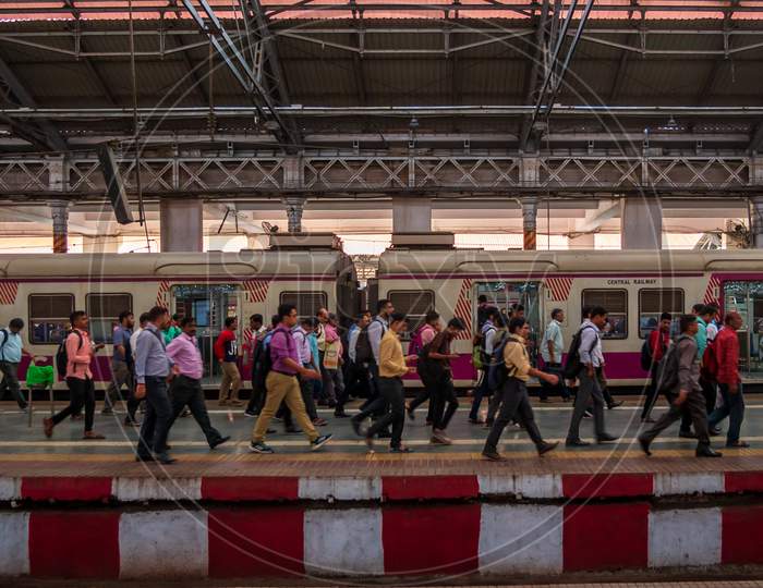 Unidentified Passengers Walking On A Platform At Rush Hours Of Cst Station, One Of The Bussiest Train Station For Working Class People In Mumbai