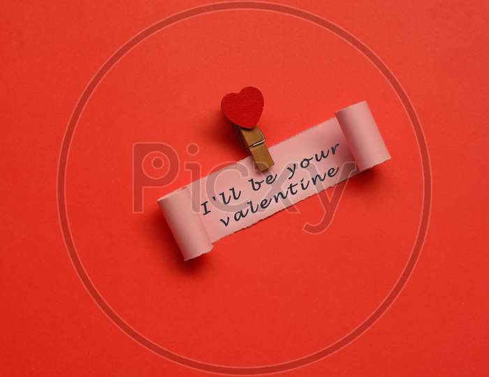 I Will Be Your Valentine Label On Torn Paper With Red Paper Background. Valentine'S Day Concept
