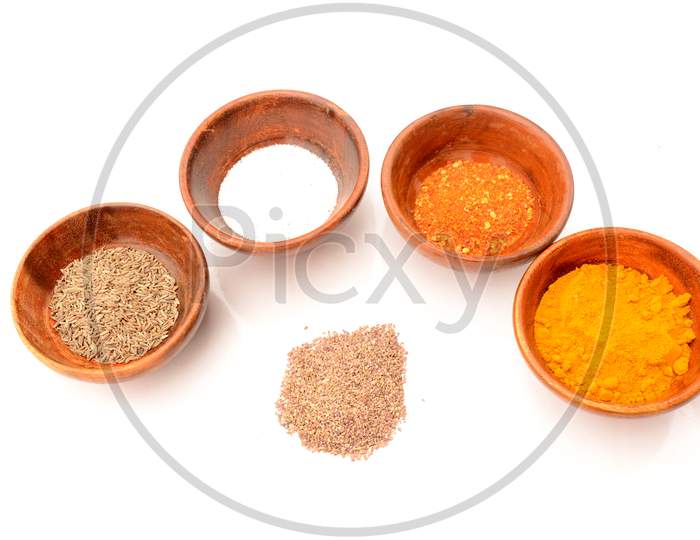 Decorative With Wooden Bowl In The Salt,Cuisine,Cumin,Chilly Powder, Turmeric, On The White Background.