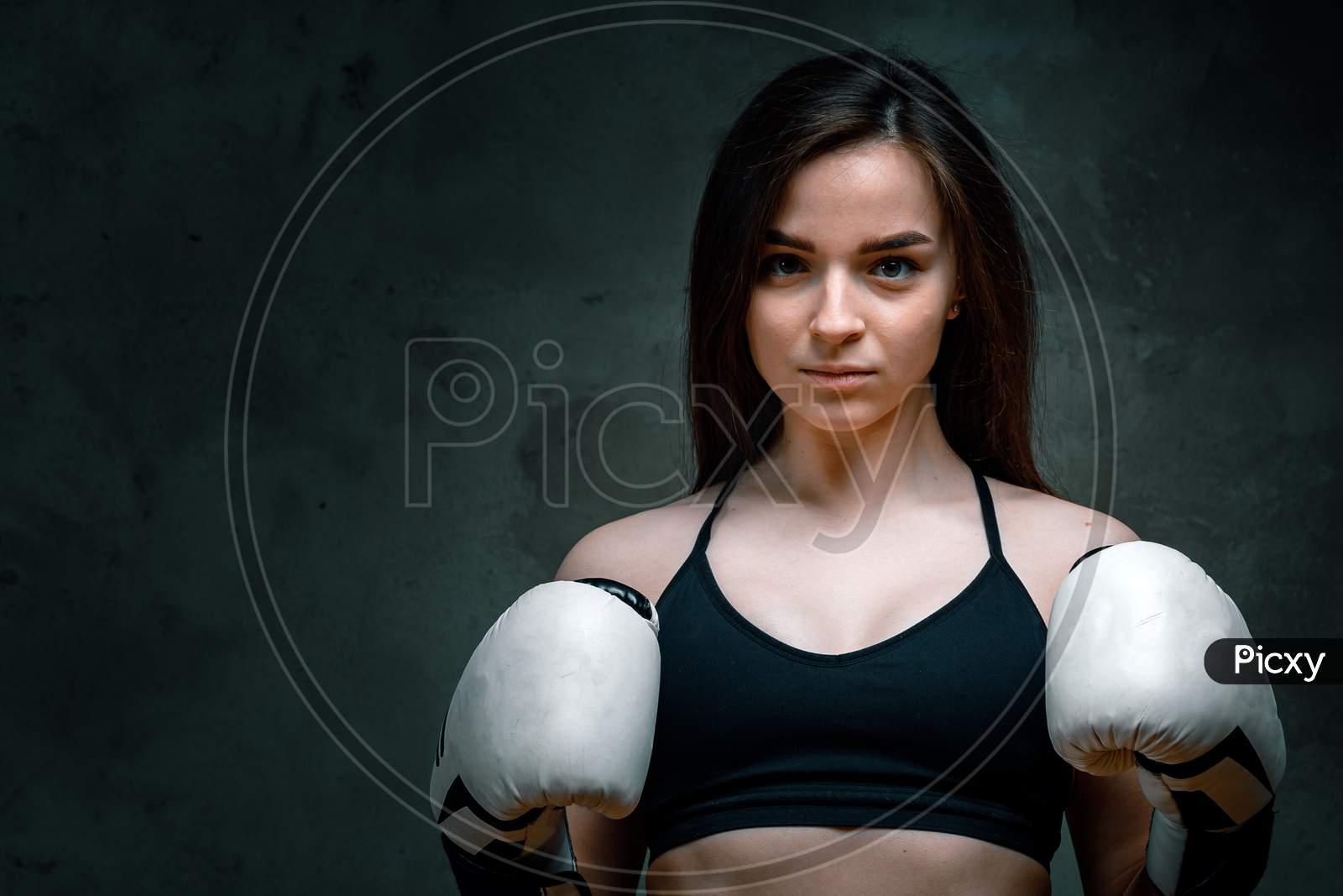 Young Fighter Girl With White Gloves Fighting Practice Throwing Aggressive Boxing Workout On Black Dirty Grunge Background