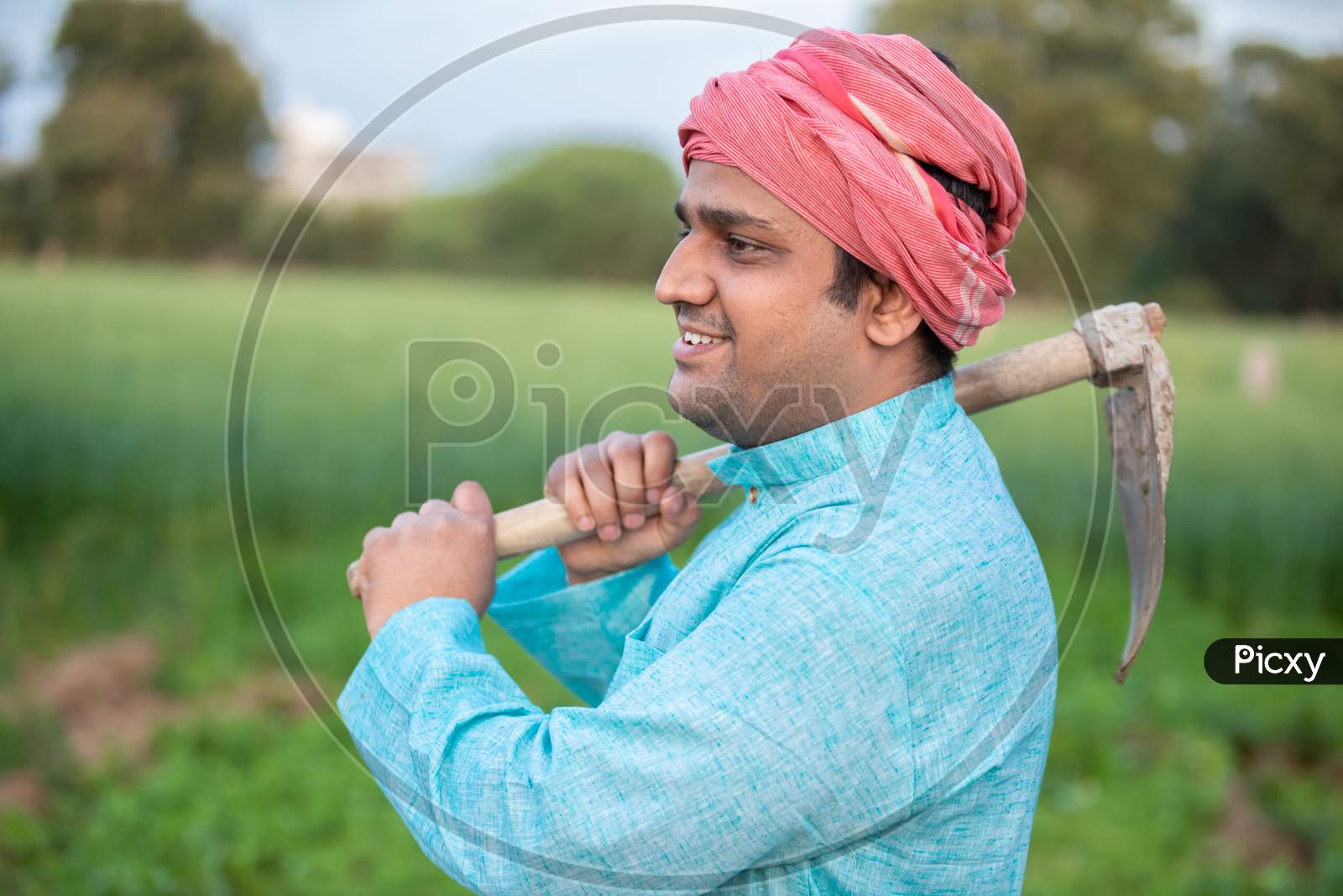Portrait Of Happy Indian Male Farmer Labor Worker Holding Pretail Garden Spade / Shovel Or Agricultural Tool.