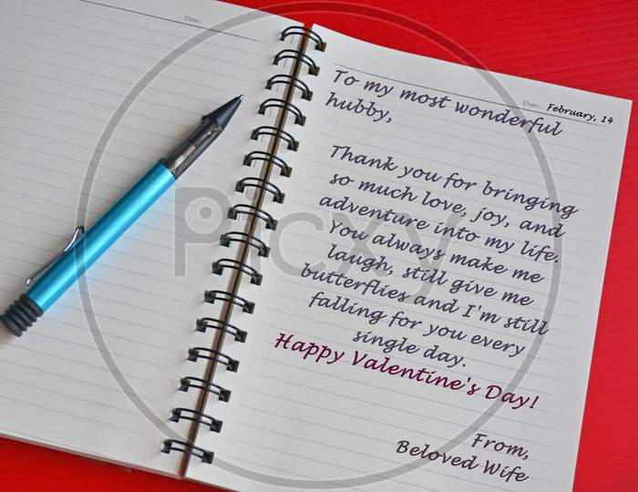 Text On White Notepad With Red Background. Top View And Valentine'S Day Concept