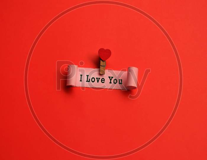 I Love You Label On Torn Paper With Red Paper Background. Valentine'S Day Concept