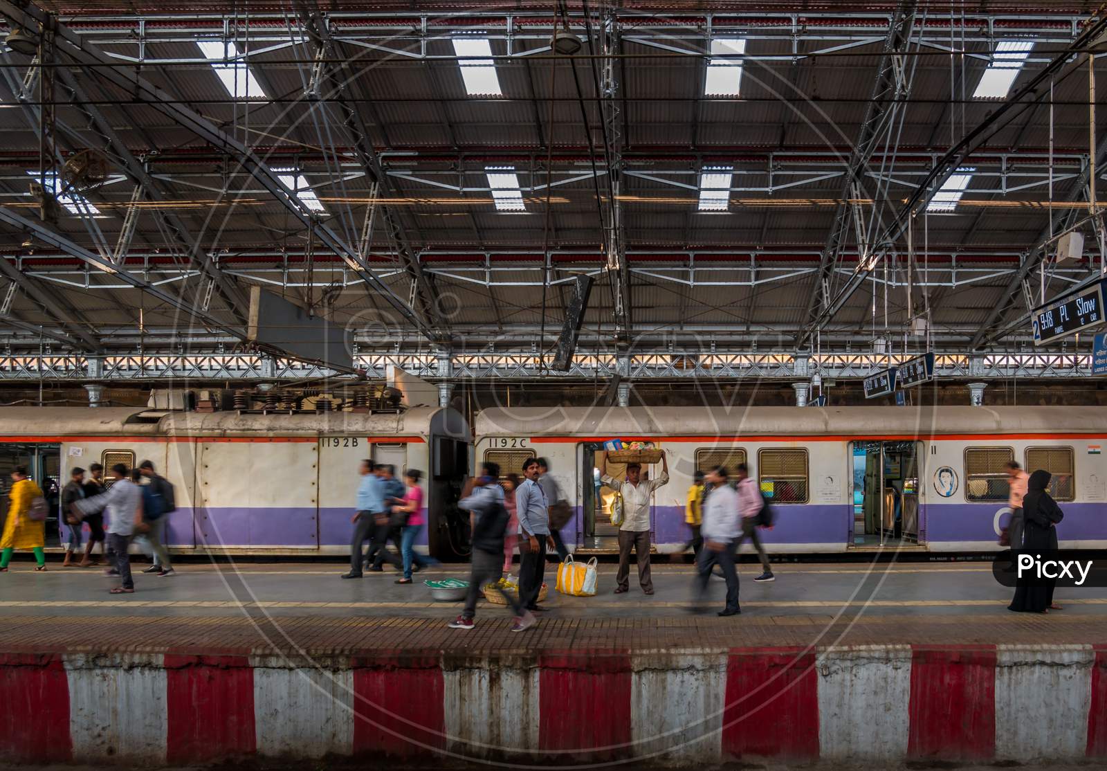 Unidentified Passengers Walking On A Platform At Rush Hours At Cst Station