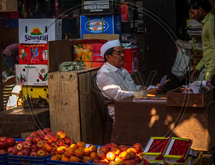 Indian Fruit Vendor With Traditional Cap At Crowford Market