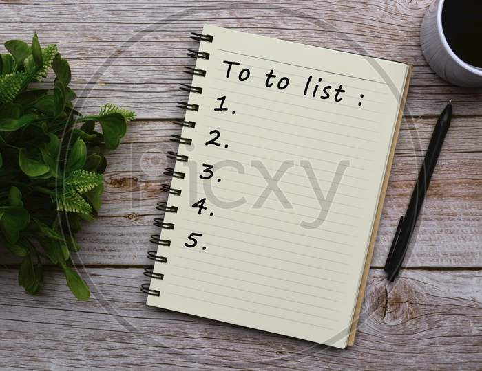 To Do List Text On Notepad On Wooden Desk