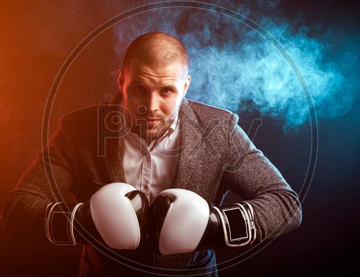 Man Businessman In Gray Suit And Boxing Gloves