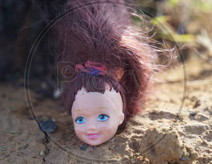 Smiley Face Of Baby Doll With Attractive Red Blond Hair. Rubber Doll Closeup For Kids. Childhood Concept.
