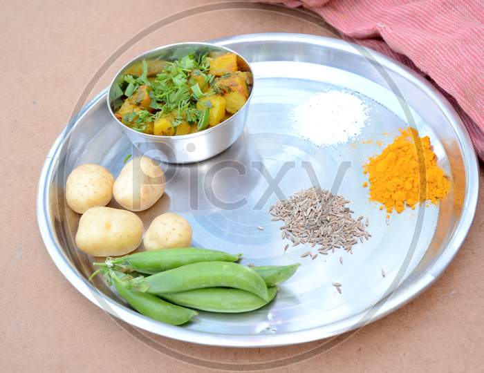 Potato With Peas Vegetable Food With Anise ,Turmeric With Red Cloth On The Brown Background.