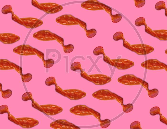 Pink Condom background opened used condoms arranged on sexual pattern