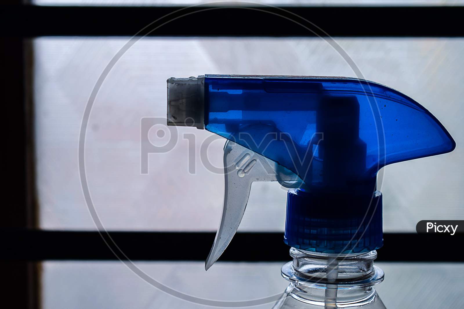 Stock Photo Of A Blue Color Trigger Pistol Spray Bottle Kept In Front Of Window Used For Cleaning Purpose At Home In Bangalore City Karnataka India