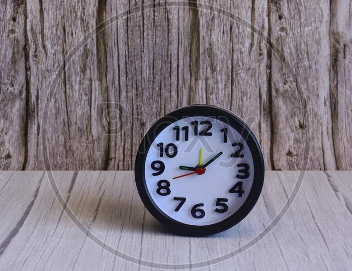 Black Alarm Clock On Wooden Table, Space For Text