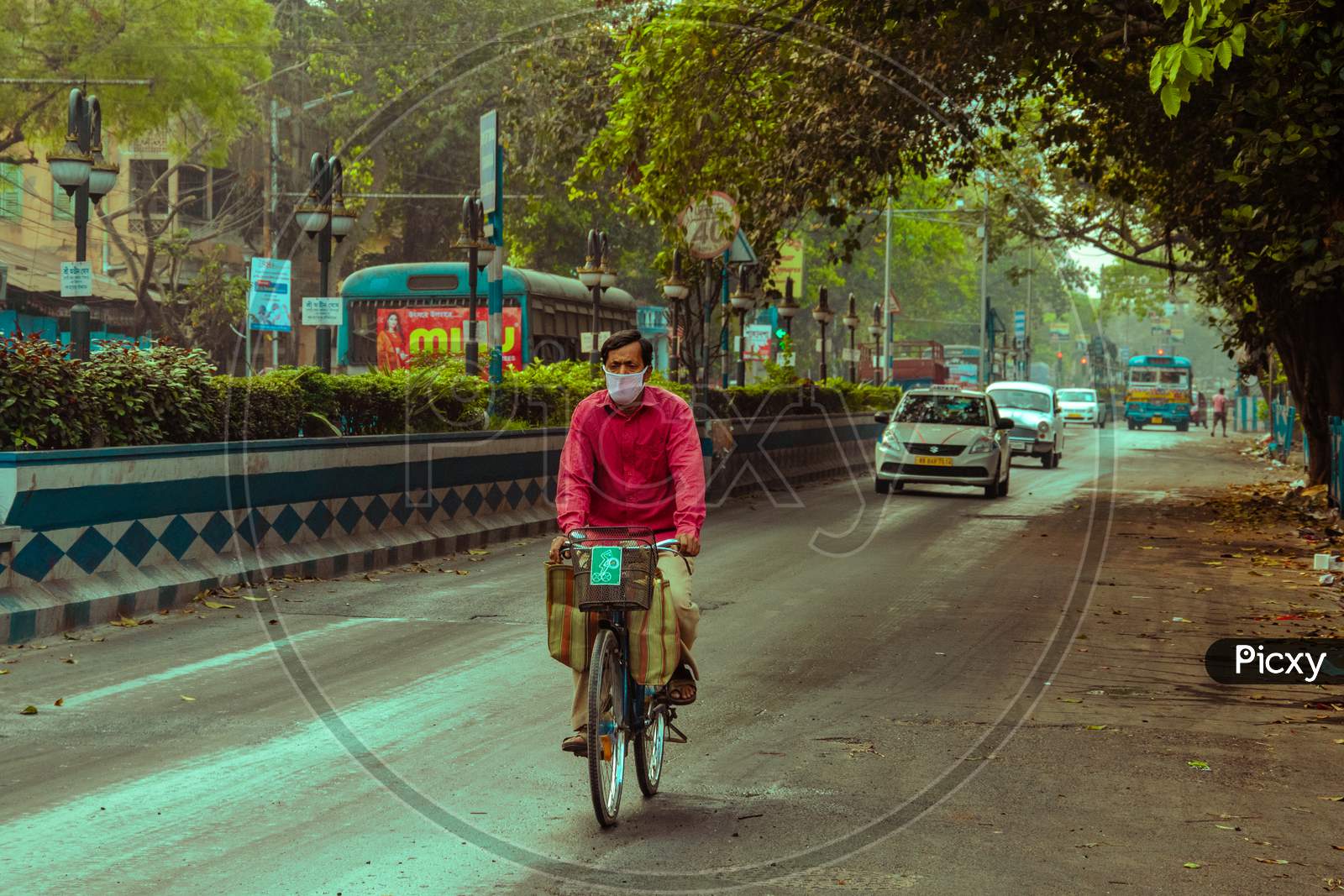 PERSON CYCLING ON THE ROADS OF KOLKATA, WEST BENGAL.