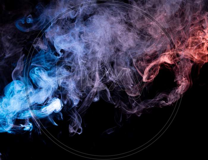Abstract Art Blue And Red Colored Smoke On Black Isolated Background. Stop The Movement Of Multicolored Smoke On Dark Background