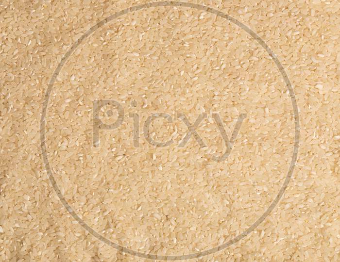 Close-Up Of Uncooked White Rice Grains. Healthy Food Concept. Dry Rice Pattern